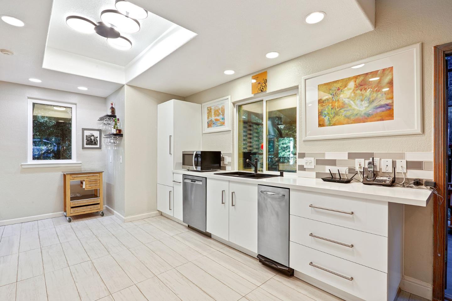 170 Swett Road Woodside, CA 94062 - Photo 10 of 36 a kitchen with granite countertop cabinets a sink a window and stainless steel appliances