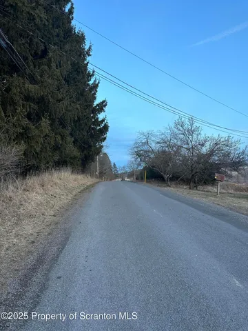 a view of a yard covered with snow in front of house