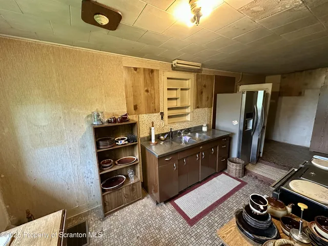 a kitchen with stainless steel appliances a refrigerator and a stove
