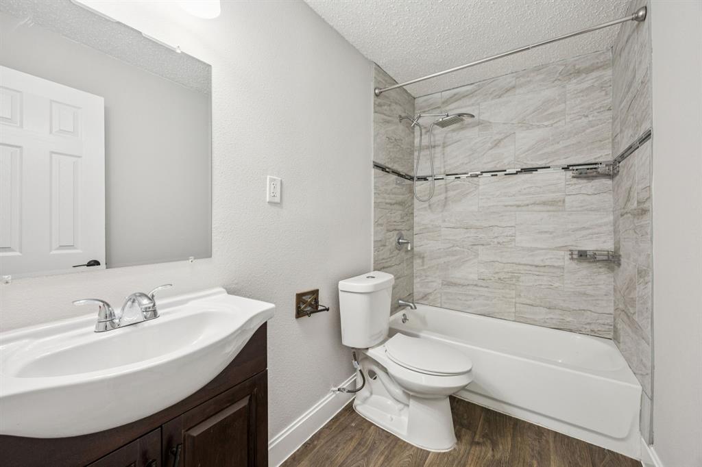 5621 Bonnie Drive Watauga, TX 76148 - Photo 17 of 40 a bathroom with a sink toilet and shower