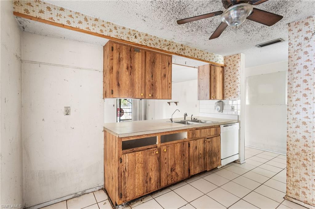 465 5th Street Southwest Naples, FL 34117 - Photo 17 of 33 Kitchen featuring light countertops, white dishwasher, a textured ceiling, ceiling fan, and light tile patterned flooring