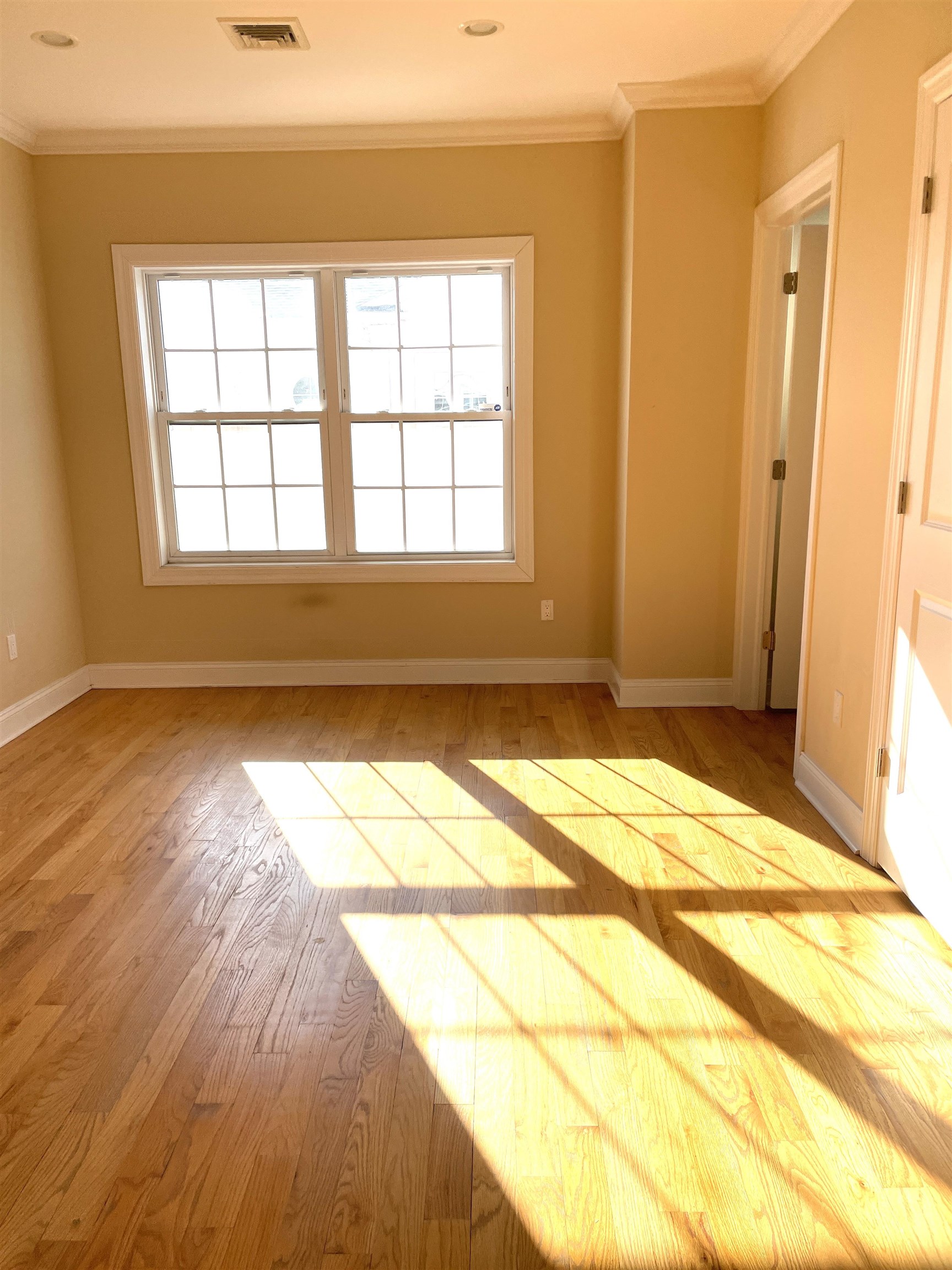 734 County Avenue, Unit B2 Secaucus, NJ 07094 - Photo 17 of 19 a view of a room with wooden floor and a window