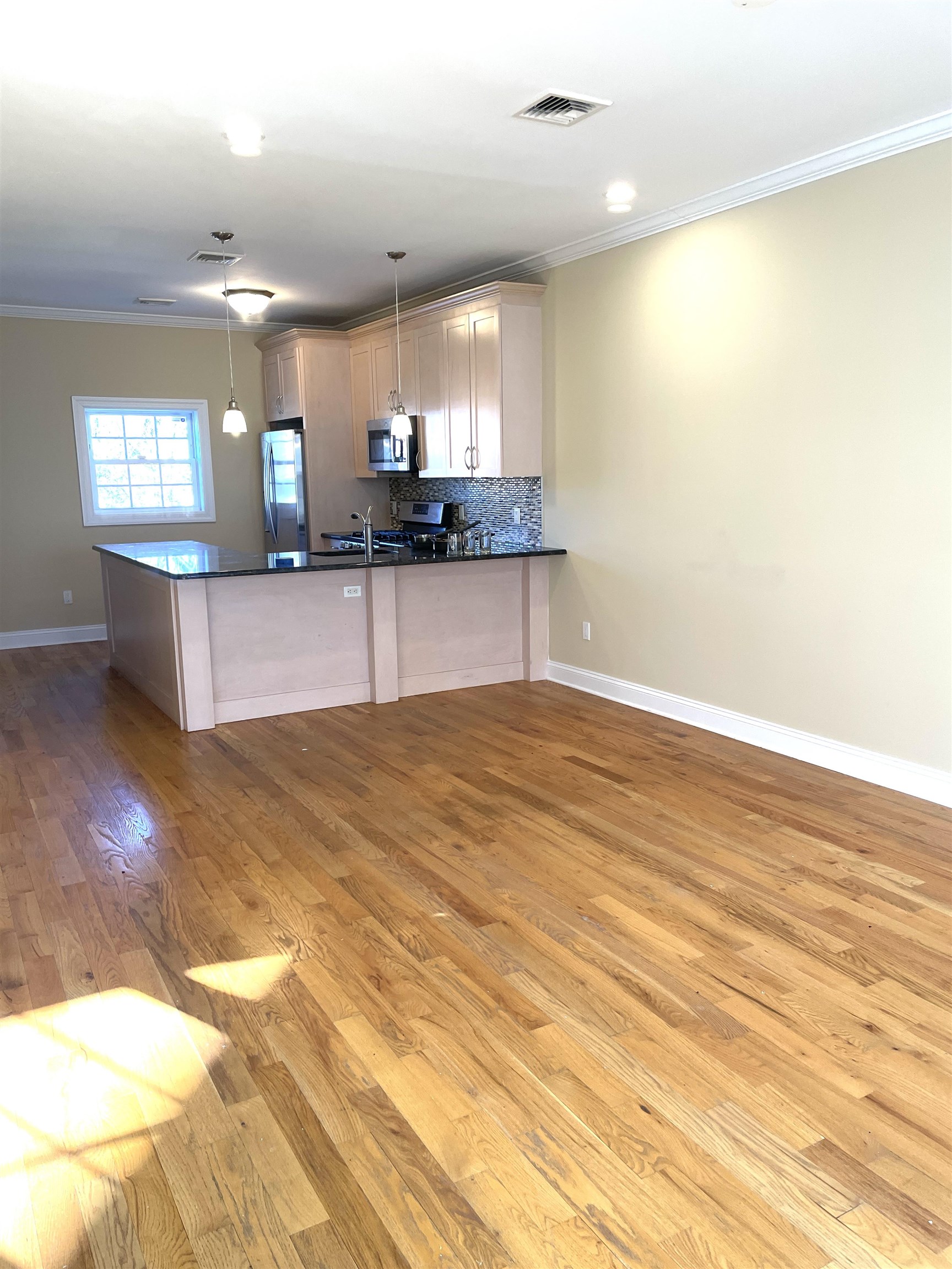 734 County Avenue, Unit B2 Secaucus, NJ 07094 - Photo 9 of 19 a large kitchen with kitchen island a sink stainless steel appliances and cabinets