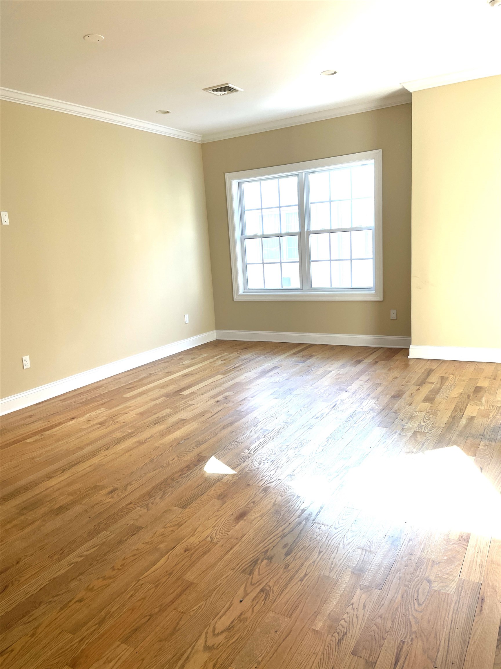 734 County Avenue, Unit B2 Secaucus, NJ 07094 - Photo 10 of 19 wooden floor in an empty room with a window