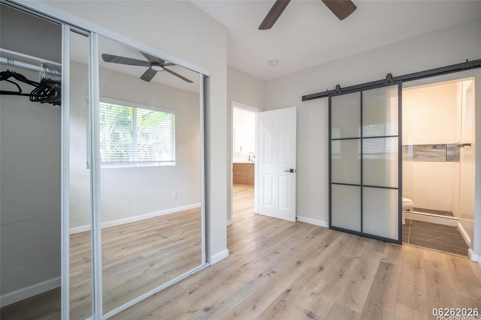 87-1409 Akowai Road Waianae, HI 96792 - Photo 24 of 25 a view of an empty room with a window and wooden floor