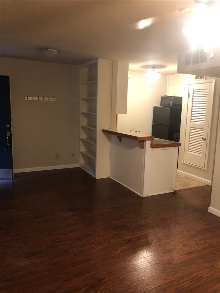 4306 Avenue A, Unit 109 Austin, TX 78751 - Photo 11 of 13 a view of a room with wooden floor and chair