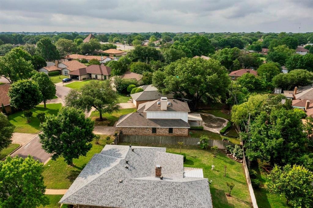 3965 Singleleaf Lane Fort Worth, TX 76133 - Photo 36 of 39 Aerial perspective showcasing a residential property with a shingled roof and multiple chimneys