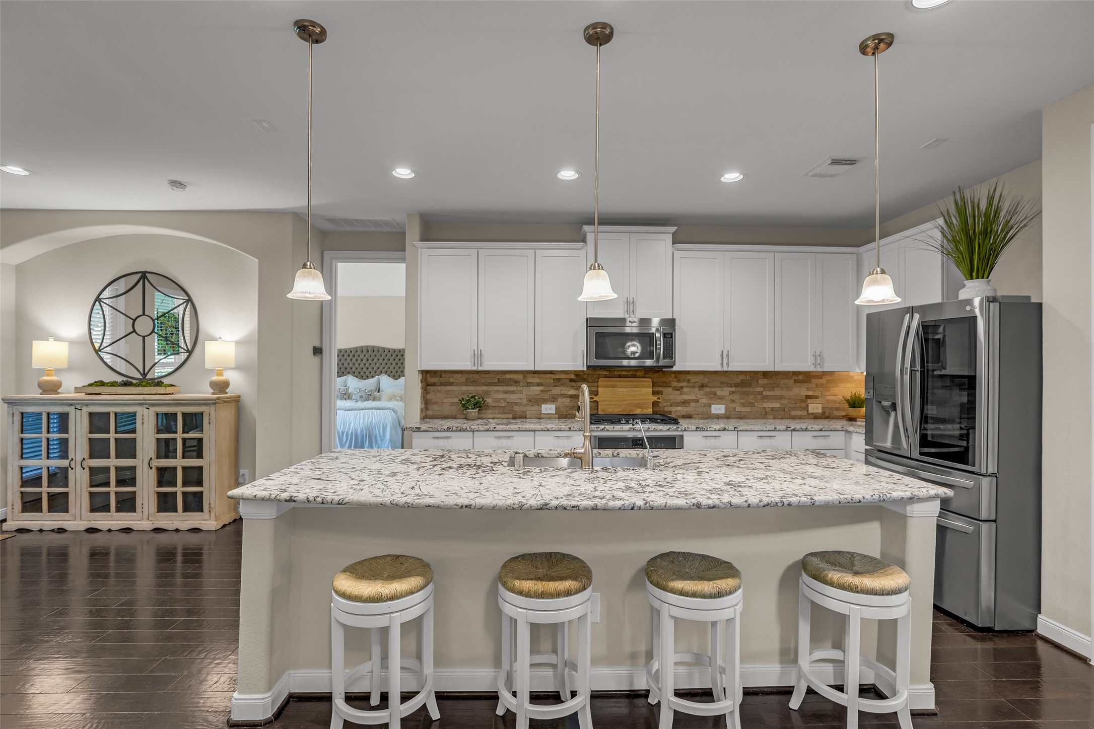 22419 Sawmill Ranch Drive Spring, TX 77389 - Photo 13 of 45 Granite counters, pendant lights, and stone backsplash highlight this space.