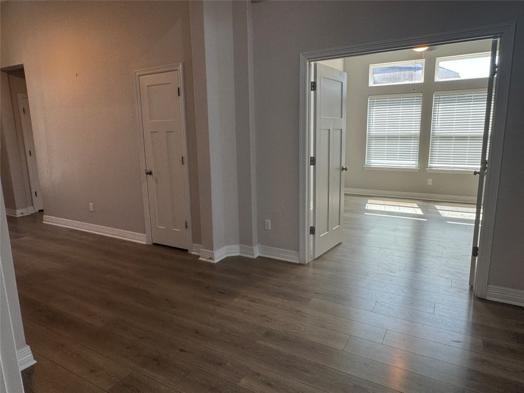 812 Karst Cove Georgetown, TX 78628 - Photo 12 of 40 an empty room with wooden floor and windows
