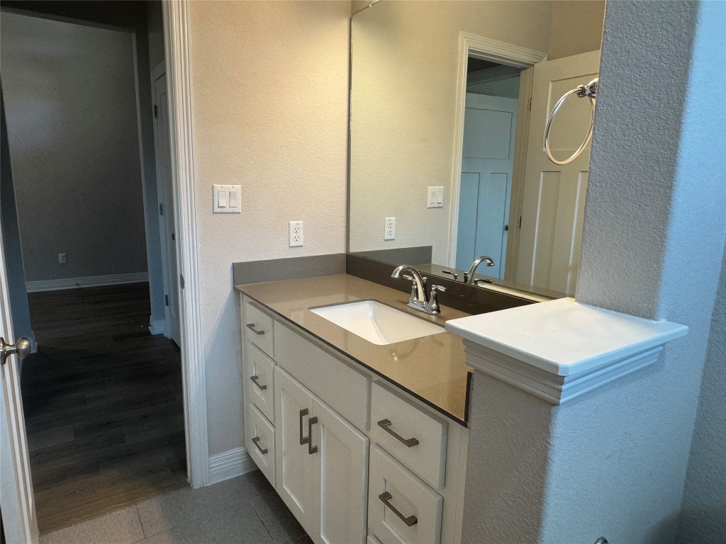 812 Karst Cove Georgetown, TX 78628 - Photo 35 of 40 a bathroom with a sink and a mirror