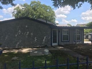 1119 Spur Street, Unit A Austin, TX 78721 - Photo 2 of 10 A quaint residential exterior offers a secure fenced front yard and ample outdoor space.