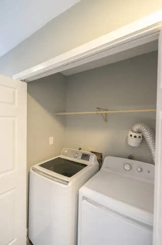 a view of kitchen with sink and refrigerator