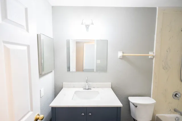 a bathroom with a sink toilet tub and shower