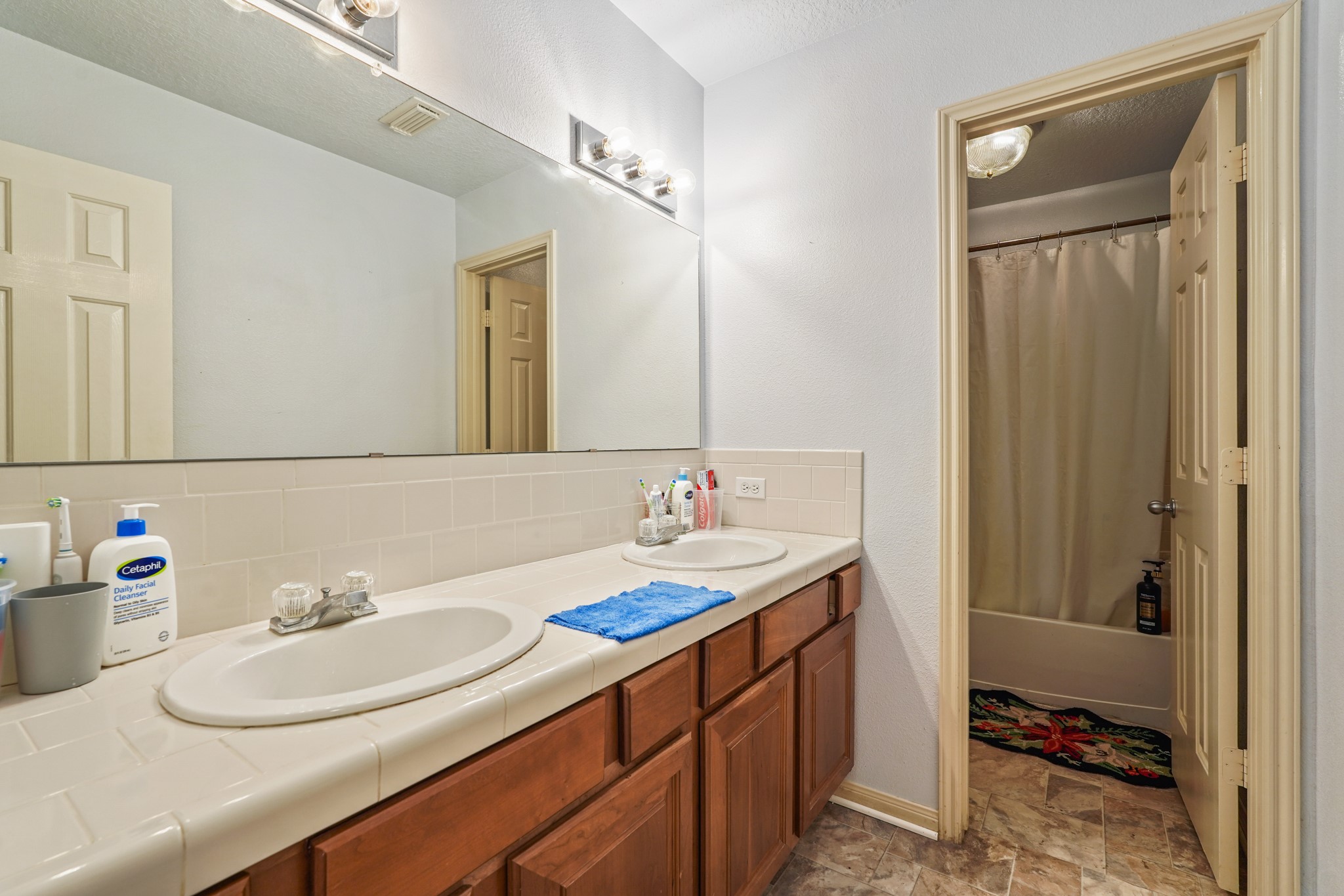 14616 Grant Road Cypress, TX 77429 - Photo 13 of 18 a bathroom with a sink and a mirror