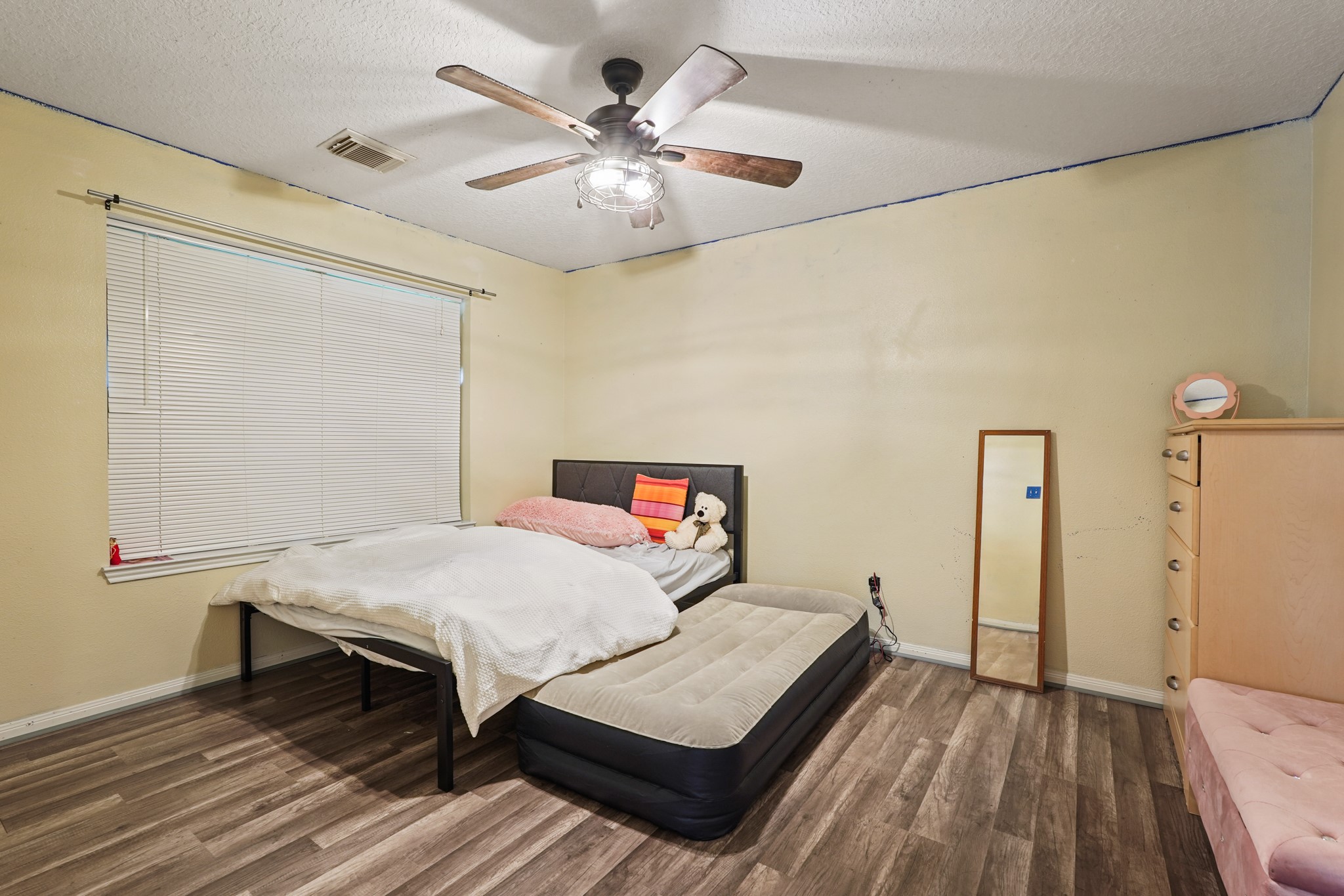 14616 Grant Road Cypress, TX 77429 - Photo 14 of 18 a bedroom with a bed and a chandelier