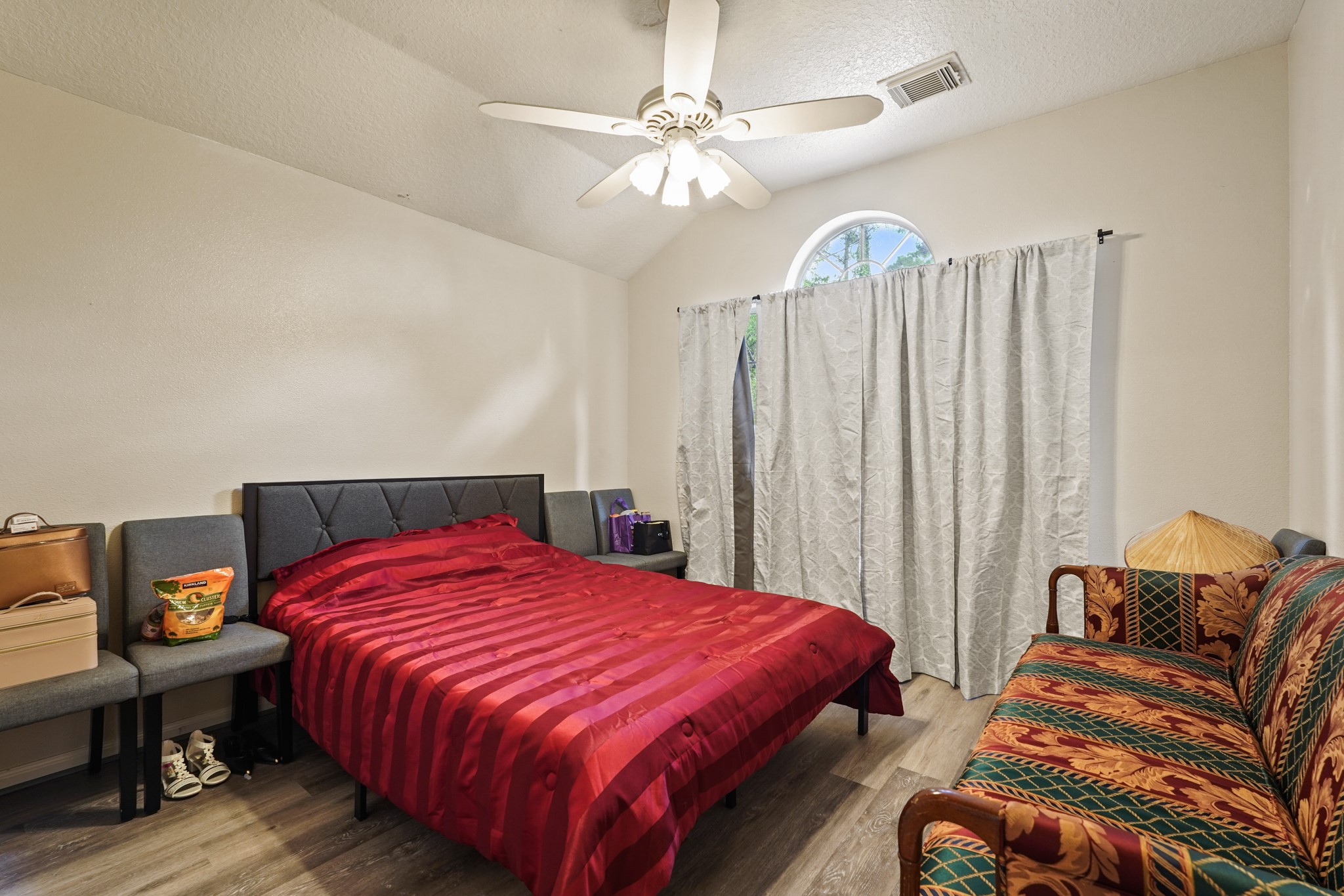 14616 Grant Road Cypress, TX 77429 - Photo 15 of 18 a bedroom with a bed and a chandelier