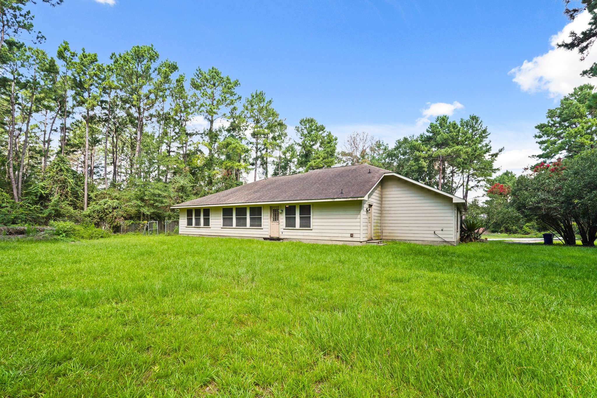 14616 Grant Road Cypress, TX 77429 - Photo 16 of 18 a front view of a house with a garden