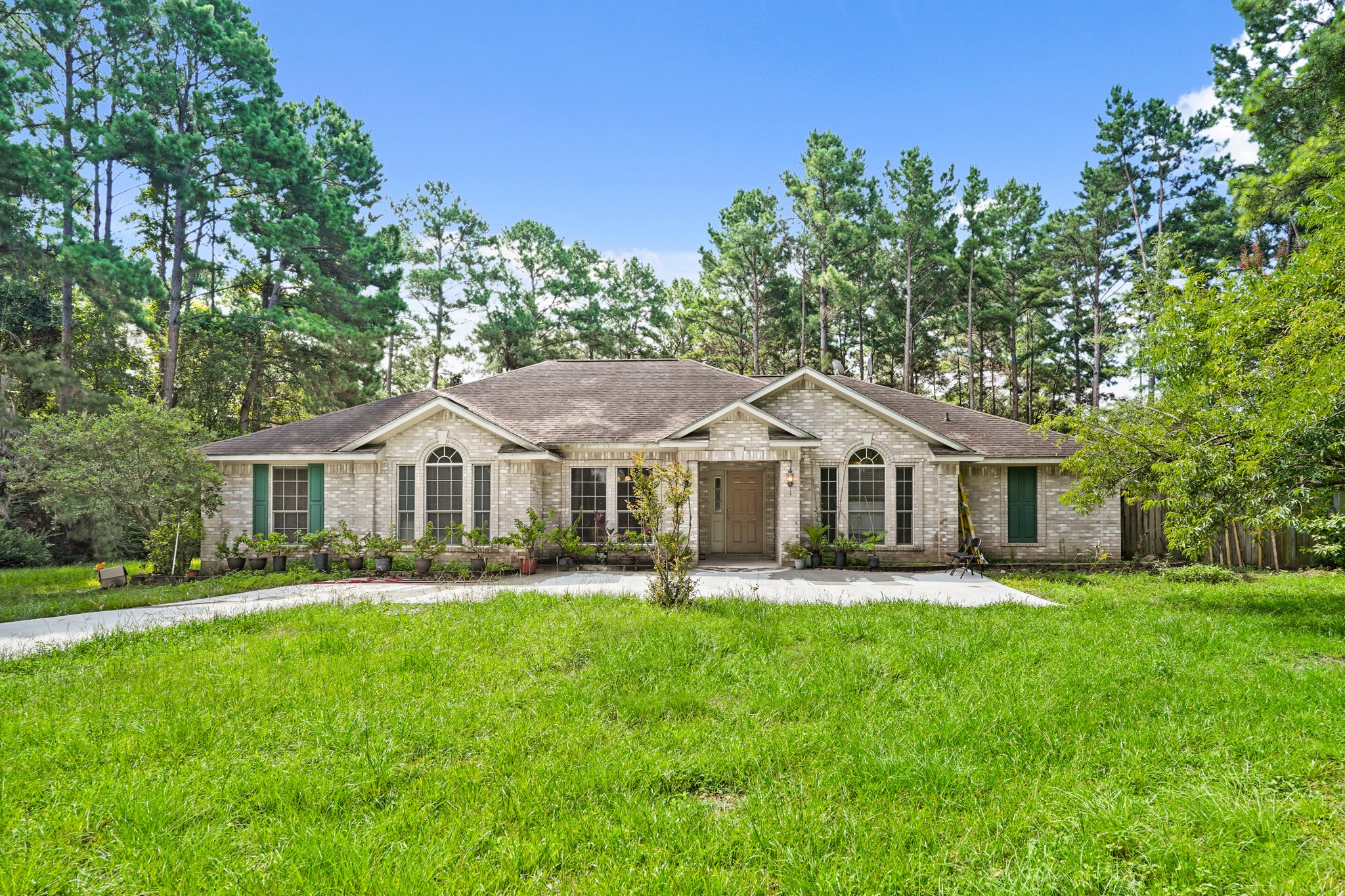 14616 Grant Road Cypress, TX 77429 - Photo 3 of 18 a front view of a house with a garden