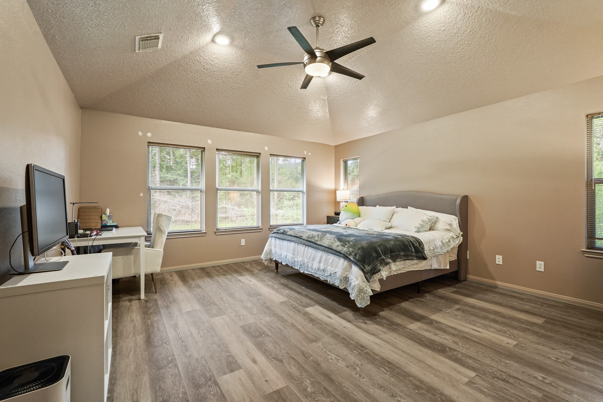 14616 Grant Road Cypress, TX 77429 - Photo 9 of 18 a bedroom with a bed a desk and chair with wooden floor