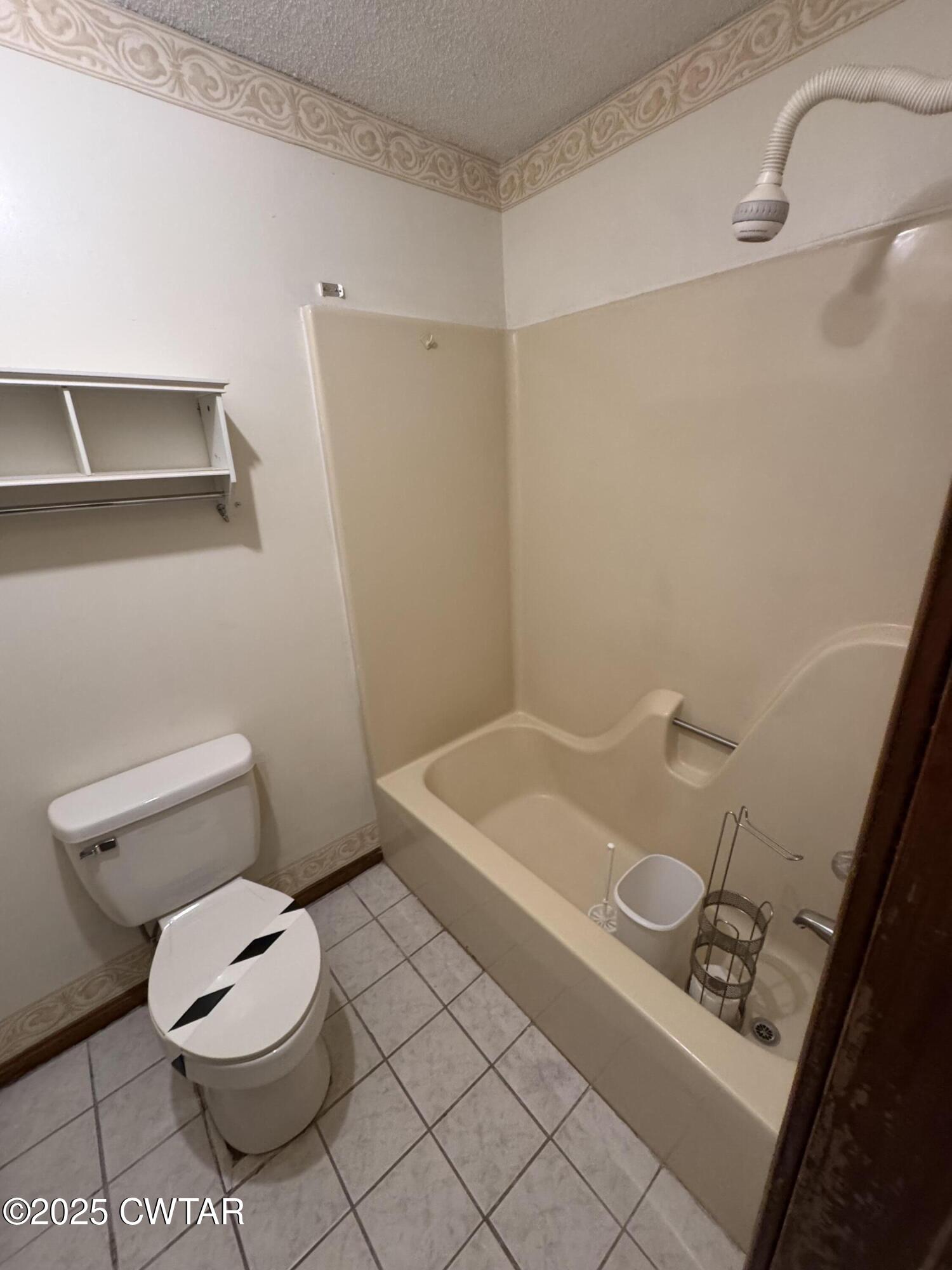 274 Fox Ridge Road Jackson, TN 38305 - Photo 11 of 16 a white toilet sitting next to a bathroom sink and vanity