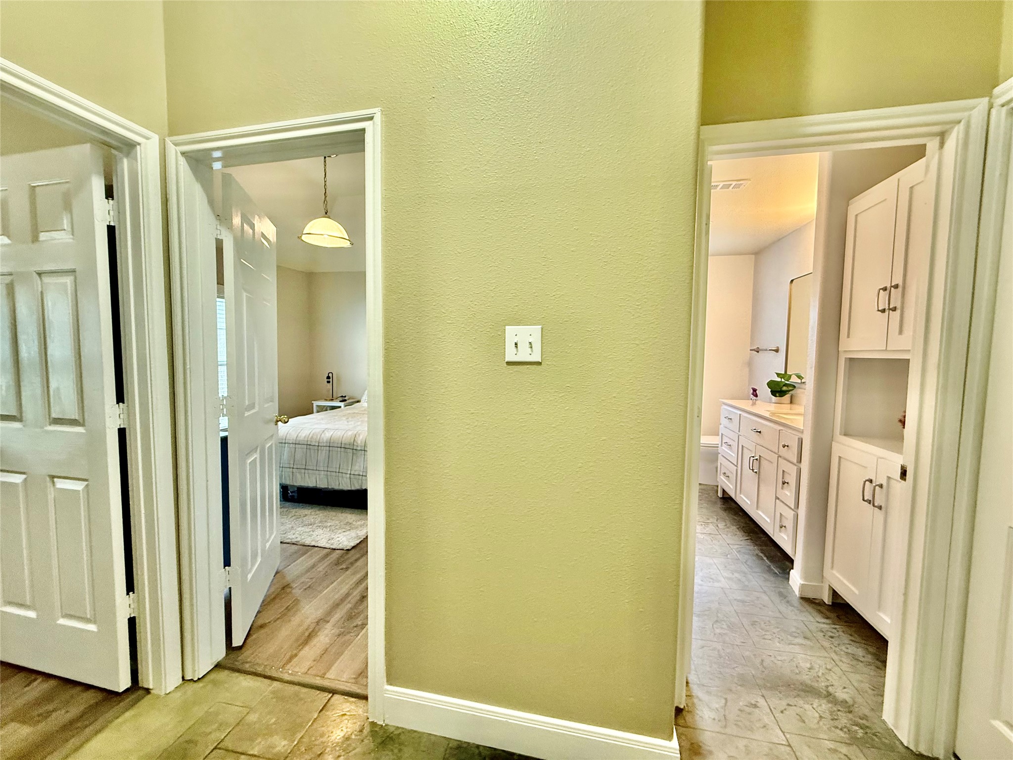 1127 Robin Road Elgin, TX 78621 - Photo 14 of 19 Corridor with a textured wall and light wood-style floors