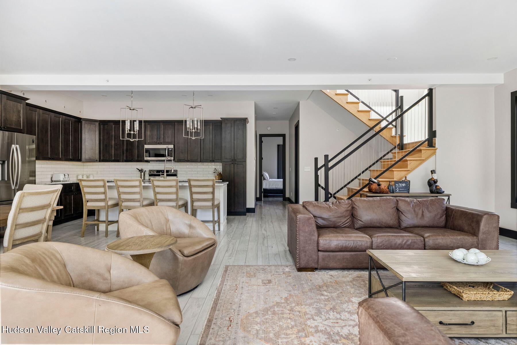 3 South Street Windham, NY 12496 - Photo 12 of 61 a living room with furniture and a view of kitchen