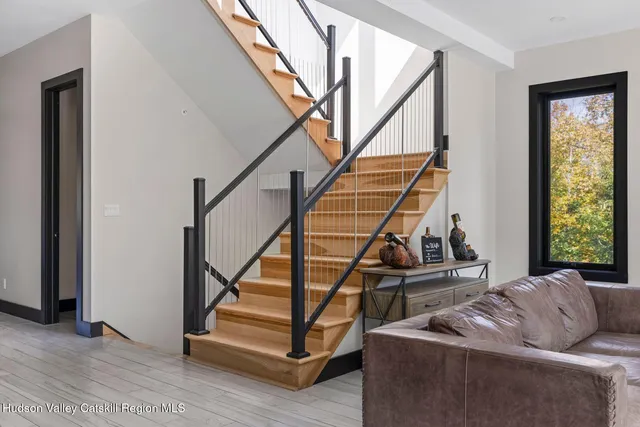 a living room with furniture and a hard wood floor