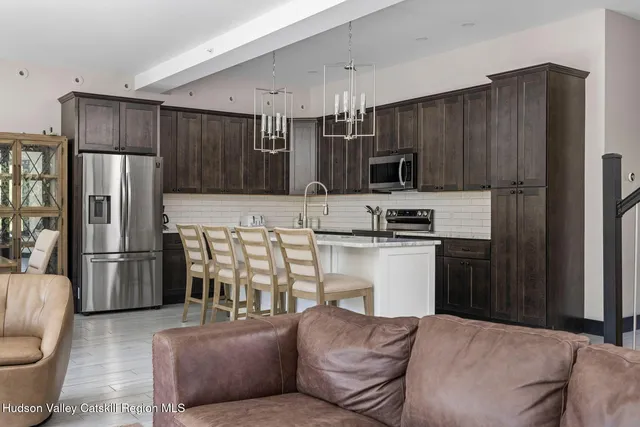 a kitchen with kitchen island granite countertop wooden cabinets and a stainless steel appliances