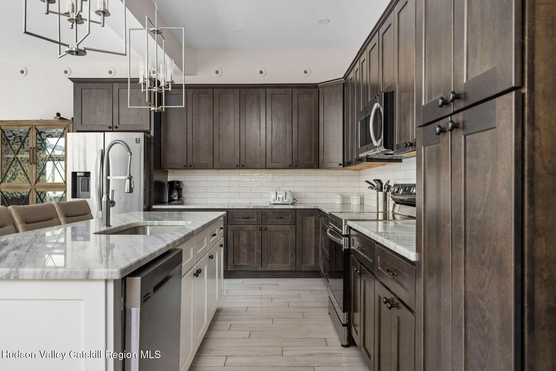 3 South Street Windham, NY 12496 - Photo 17 of 61 a kitchen with stainless steel appliances granite countertop a sink stove and refrigerator