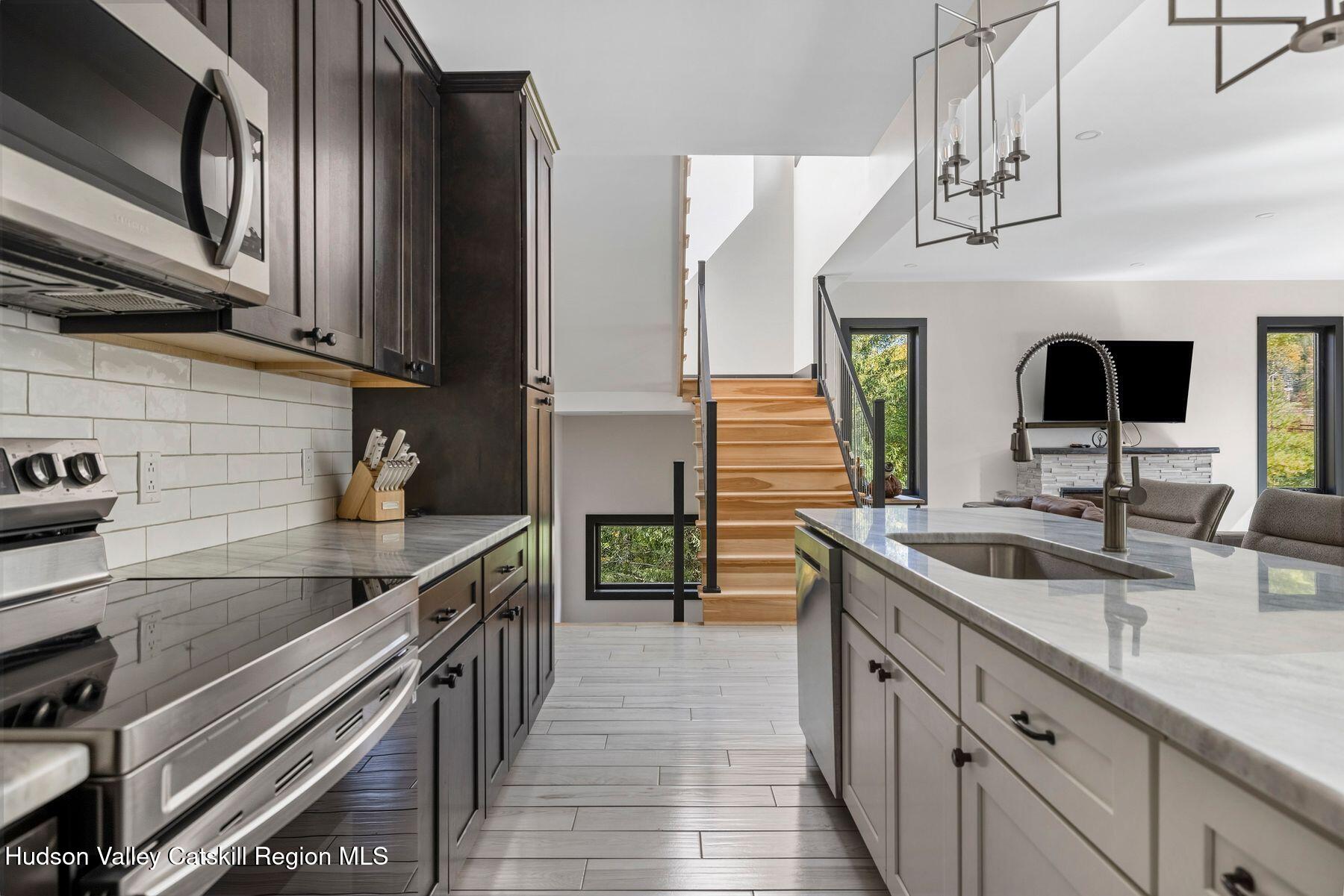 3 South Street Windham, NY 12496 - Photo 19 of 61 a kitchen with stainless steel appliances granite countertop a sink and a stove