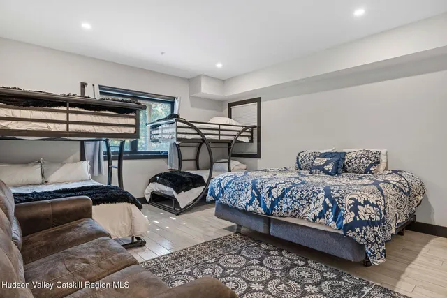 a bedroom with a bed and a mirror