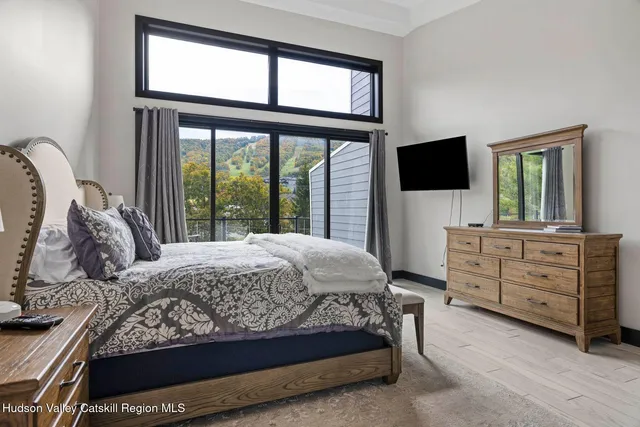 a bedroom with a bed and a mirror