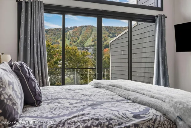 a bedroom with a bed a table and chair