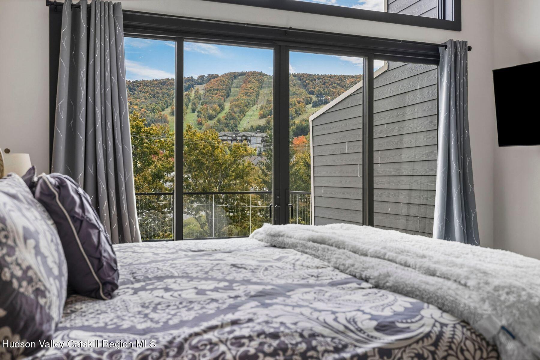 3 South Street Windham, NY 12496 - Photo 32 of 61 a bedroom with a bed and large window