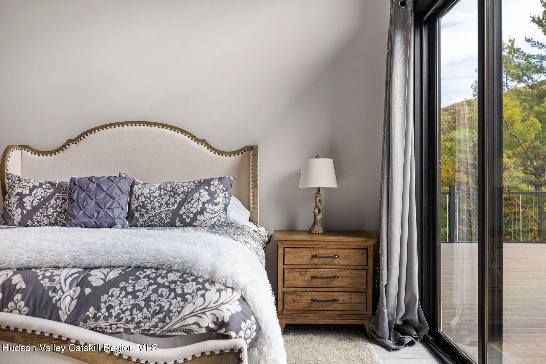 3 South Street Windham, NY 12496 - Photo 34 of 61 a bedroom with a bed and a mirror