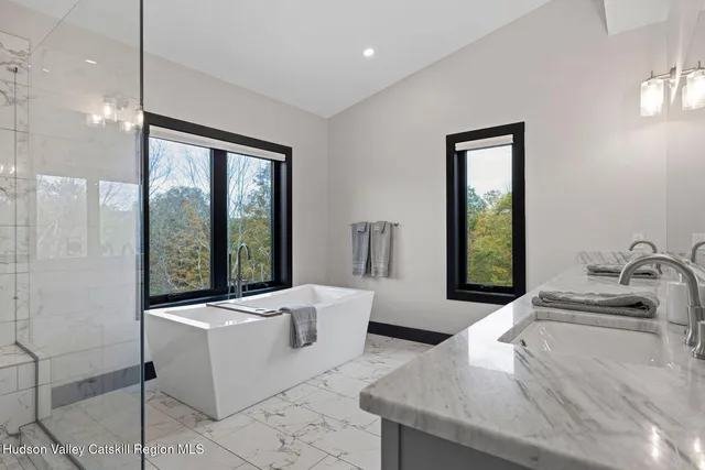 a bathroom with a granite countertop sink a toilet and shower