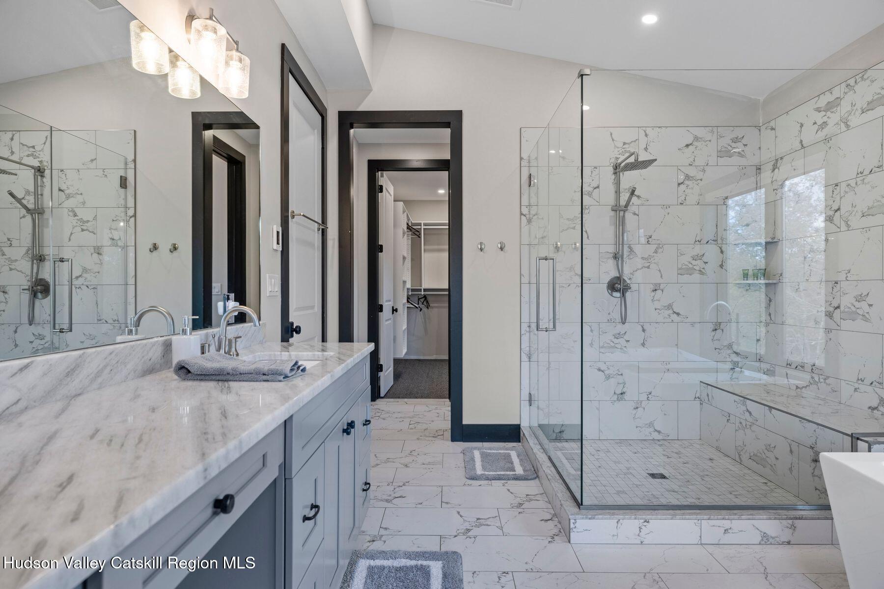 3 South Street Windham, NY 12496 - Photo 40 of 61 a spacious bathroom with a shower sink and mirror