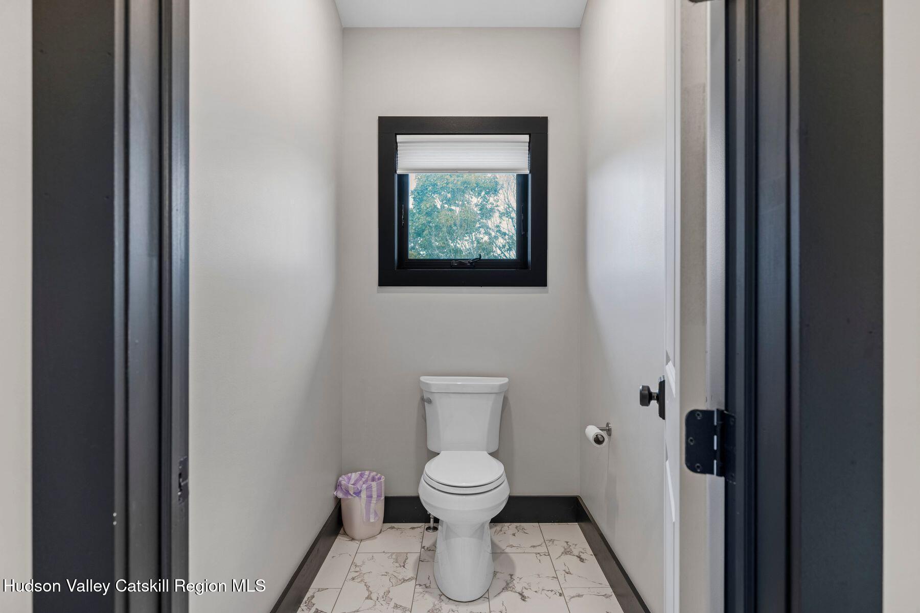 3 South Street Windham, NY 12496 - Photo 41 of 61 a bathroom with a toilet and a painting on the wall