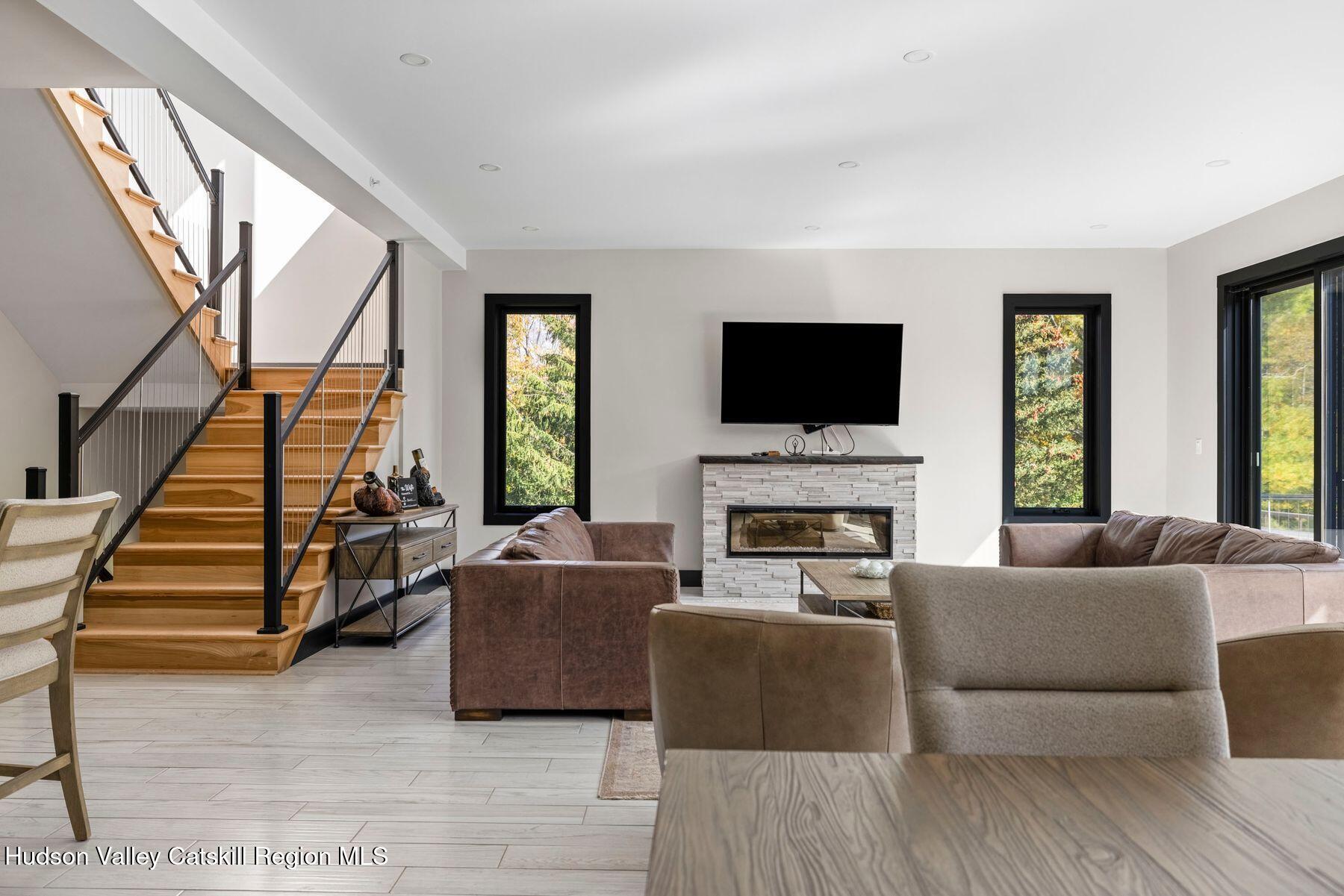 3 South Street Windham, NY 12496 - Photo 5 of 61 a living room with furniture a flat screen tv and a fireplace
