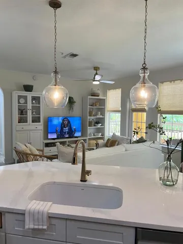 a kitchen with a sink stainless steel appliances and a counter top space