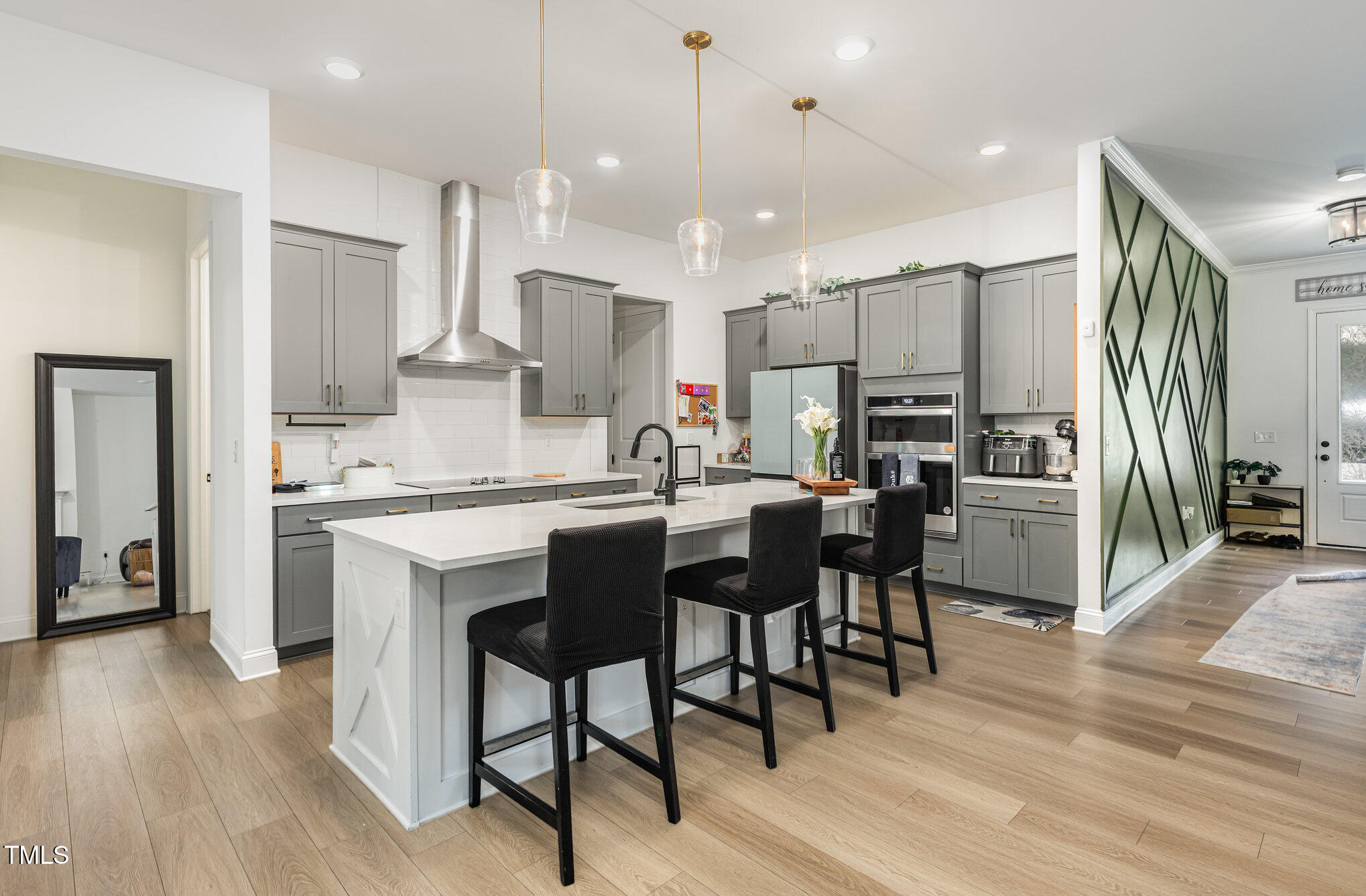 25 Cackling Way Zebulon, NC 27597 - Photo 15 of 32 a kitchen with stainless steel appliances kitchen island granite countertop a table chairs sink and cabinets