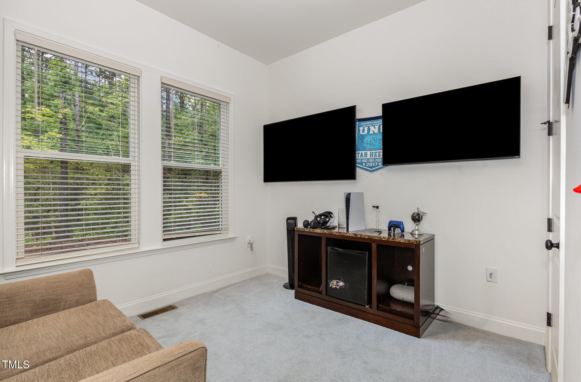 25 Cackling Way Zebulon, NC 27597 - Photo 16 of 32 a living room with furniture and a flat screen tv