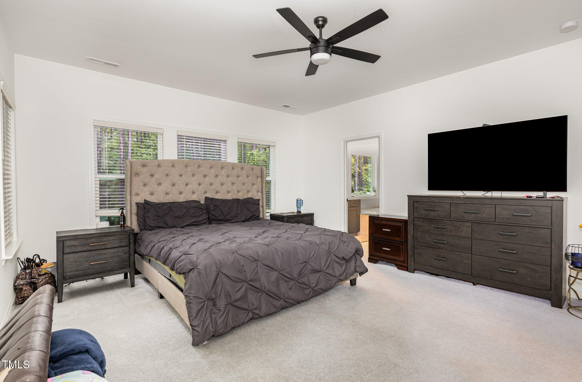 25 Cackling Way Zebulon, NC 27597 - Photo 20 of 32 a bedroom with a bed and a flat screen tv