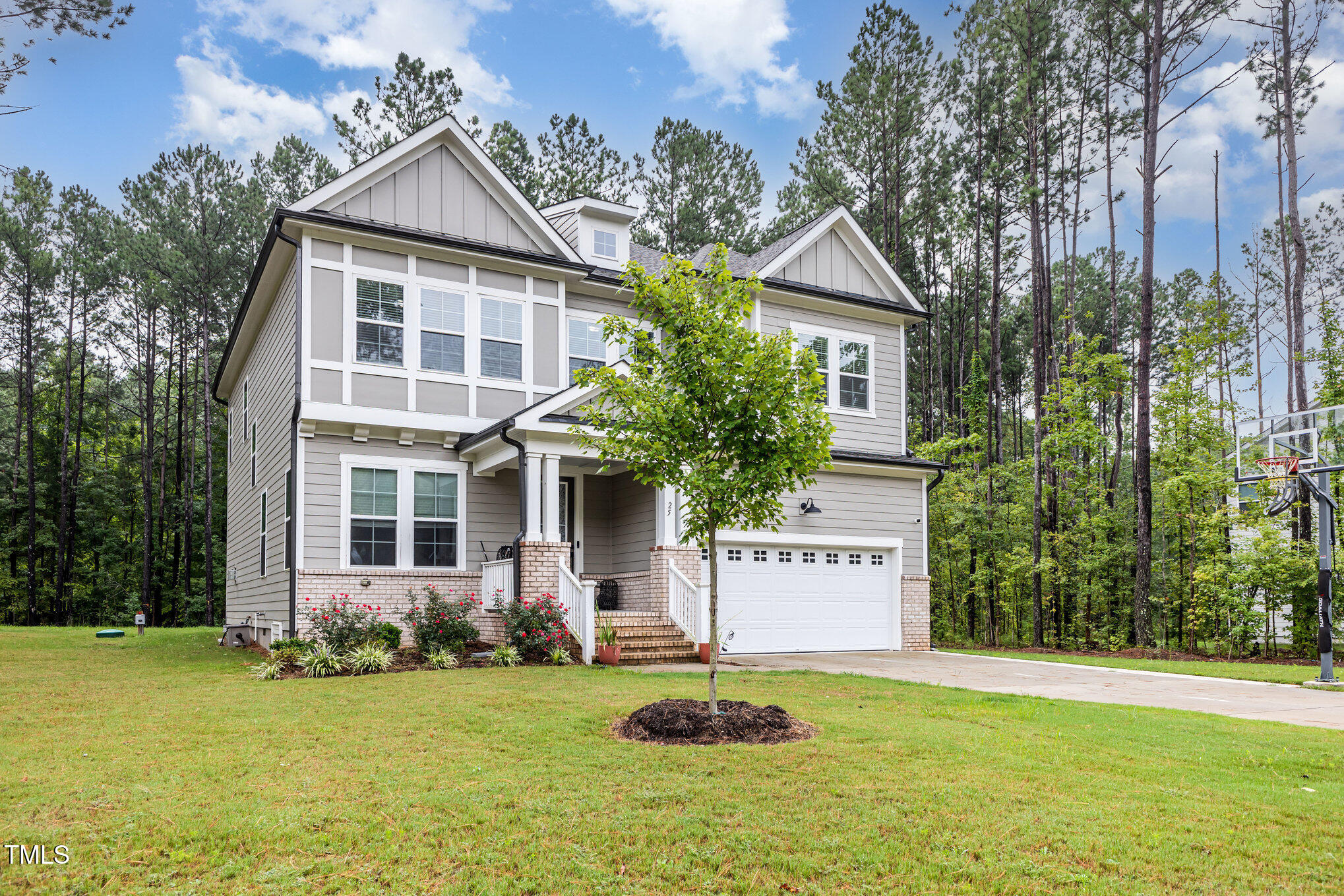 25 Cackling Way Zebulon, NC 27597 - Photo 2 of 32 a house with garden in front of it