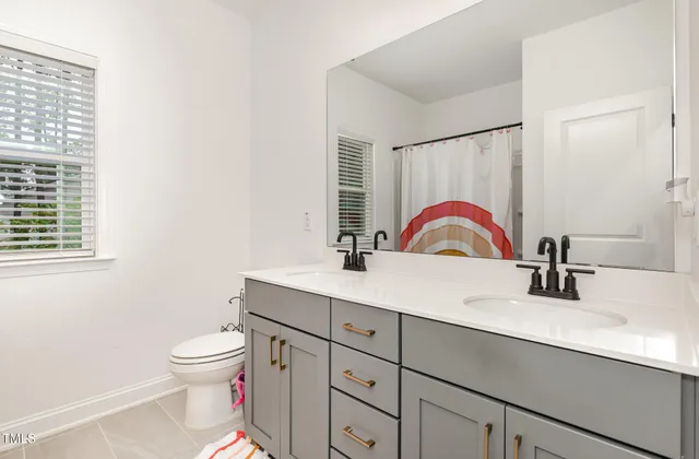 a bathroom with a sink toilet and a mirror