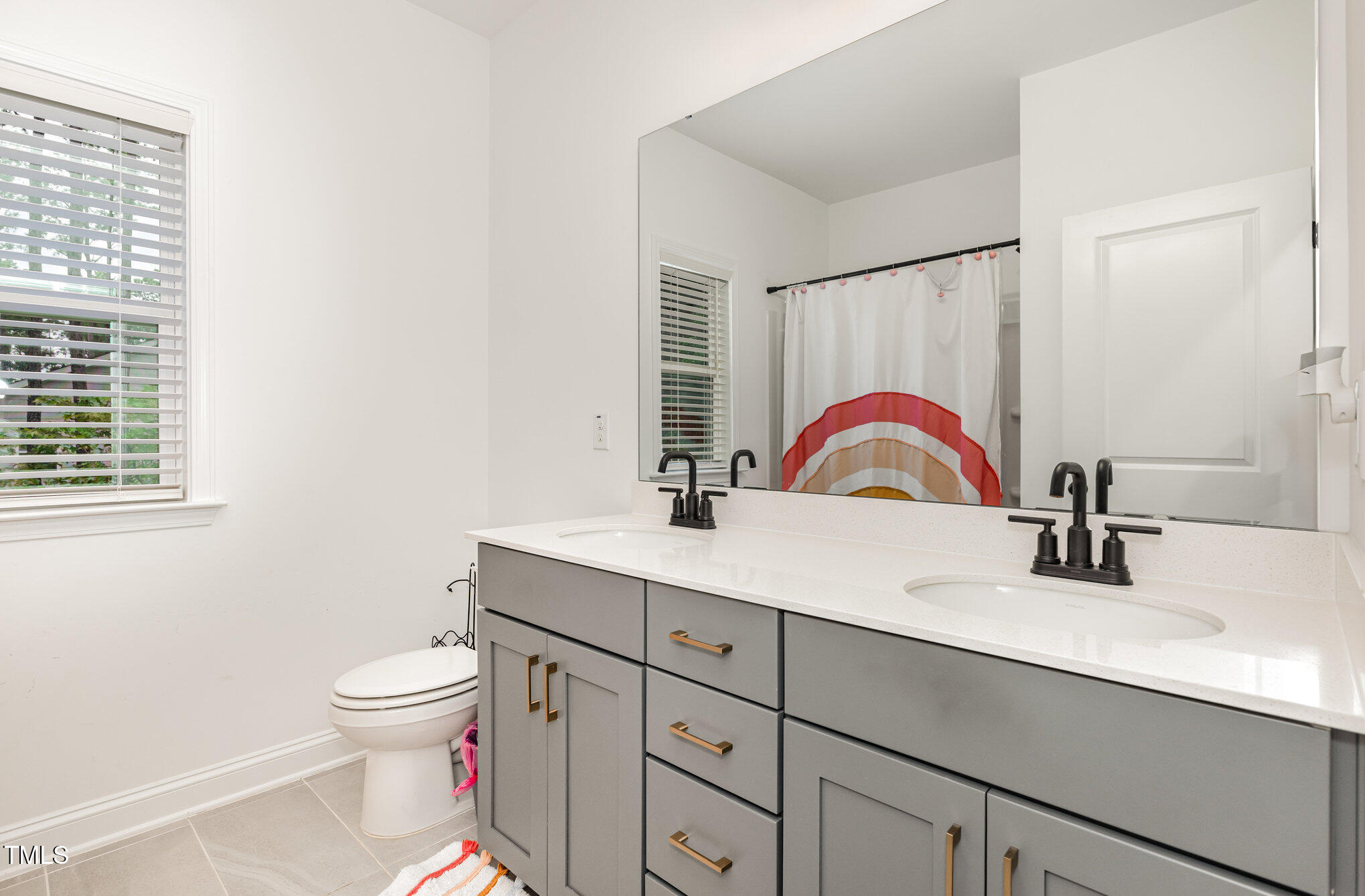 25 Cackling Way Zebulon, NC 27597 - Photo 26 of 32 a bathroom with a sink toilet and a mirror