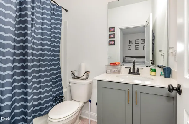 a white toilet sitting next to a bathroom sink