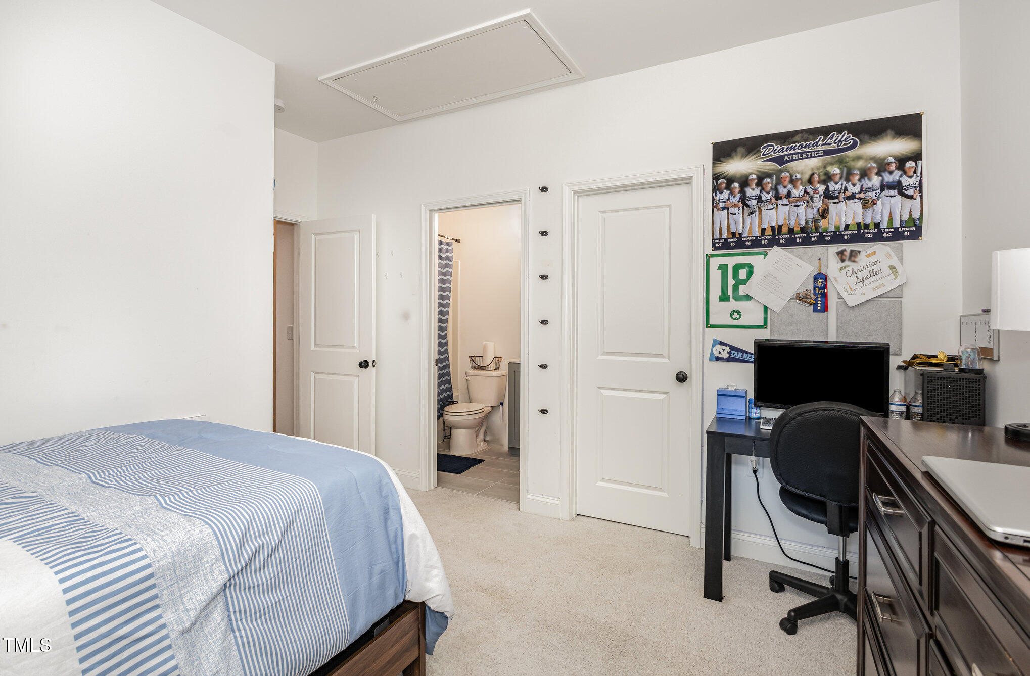 25 Cackling Way Zebulon, NC 27597 - Photo 30 of 32 a bedroom with a bed and a desk