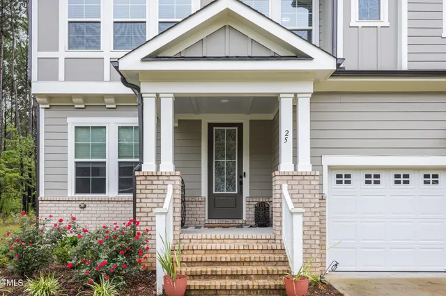 a front view of a house with a garden