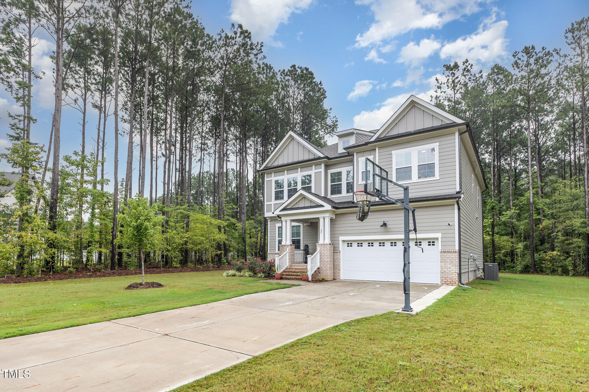 25 Cackling Way Zebulon, NC 27597 - Photo 4 of 32 a view of a house with a yard and large tree